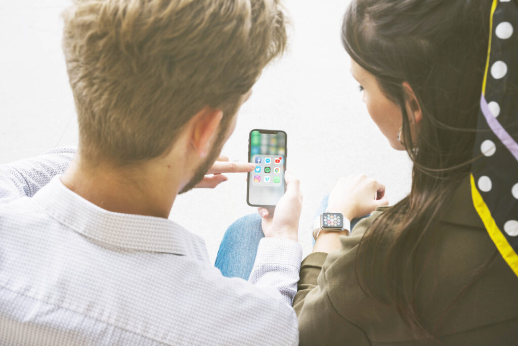 friends-using-application-mobile-phone-by-connecting-with-smart-watch