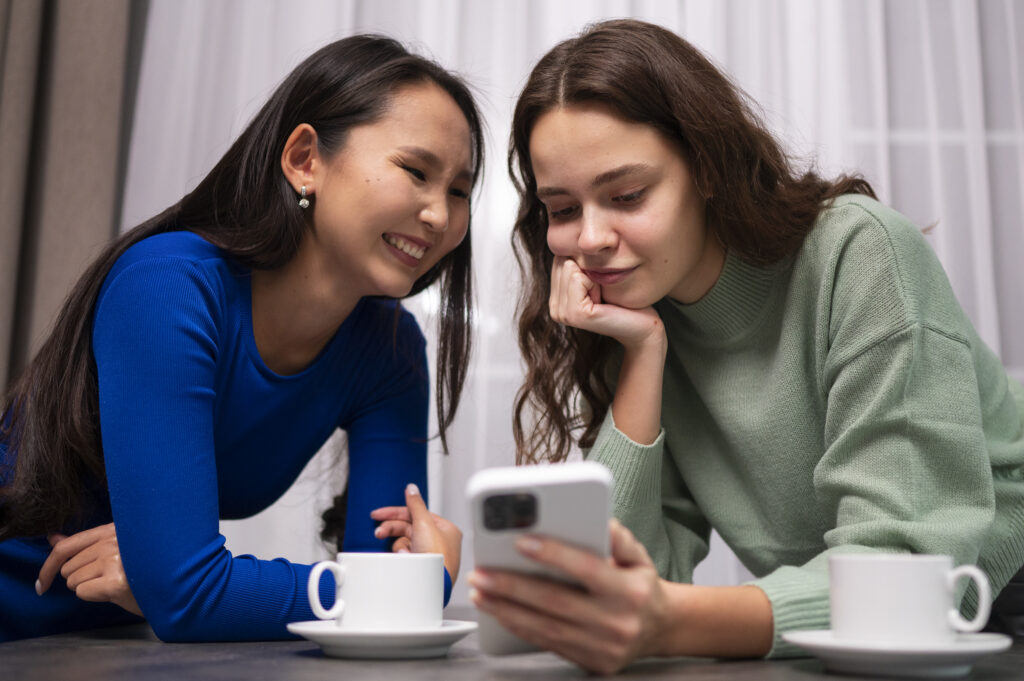 women-reading-cell-phone-messages-medium-shot