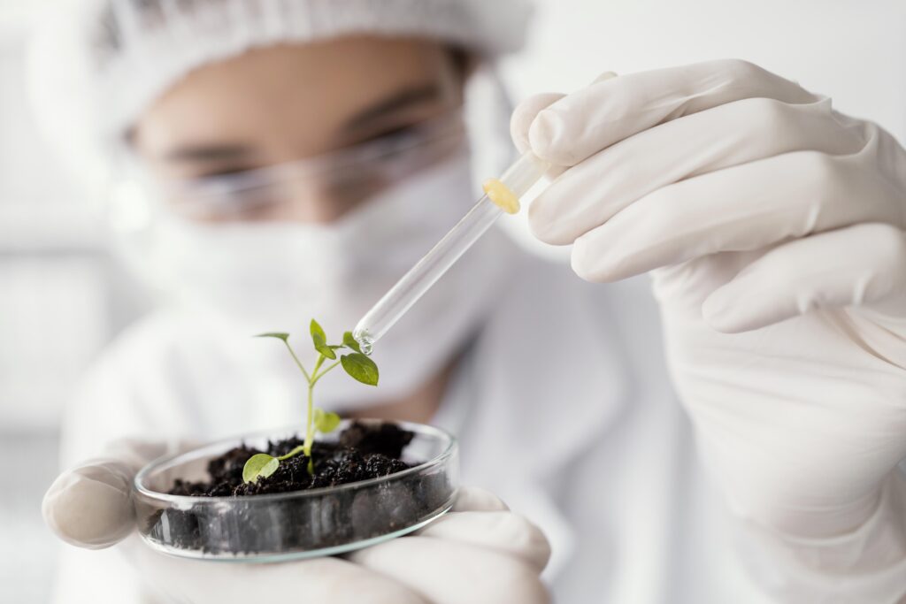 close-up-scientist-watering-plant