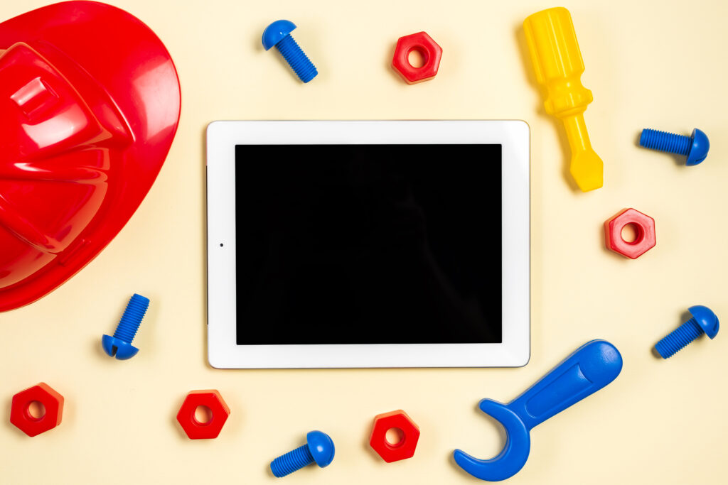 colorful-hardhat-screws-bolts-spanner-tool-screwdriver-around-digital-tablet