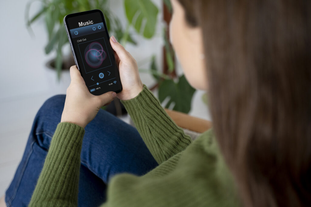 woman-putting-music-using-her-smartphone-while-being-home